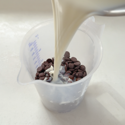 Pour hot milk over chocolate