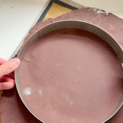 Press perforated tart ring into dough