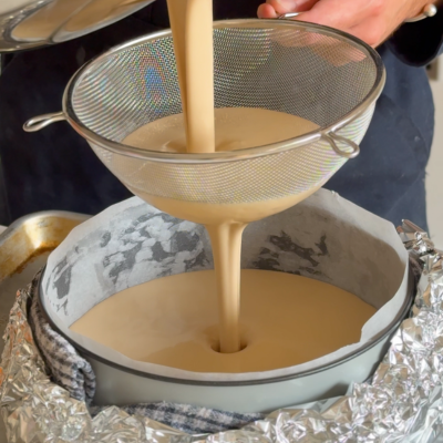 Pour batter through a sieve